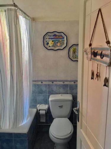 a bathroom with a toilet and a bathtub and a shower curtain at Villa a kazma Beach Gabes Tunisia in Gabès