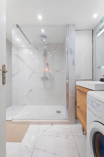 une salle de bain avec une douche avec une porte vitrée dans l'établissement Nice Renting - 3 MASSENA - Chic Escape Luxury Duplex Place Massena, à Nice