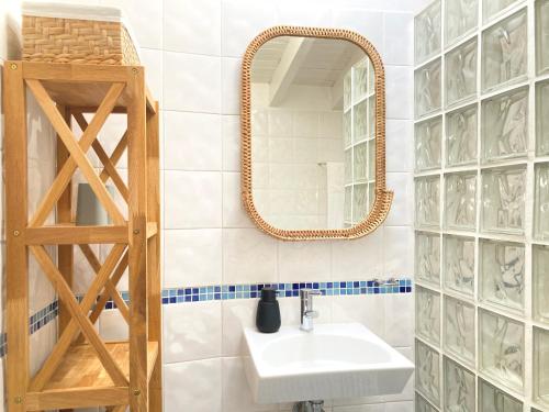 a bathroom with a sink and a mirror at Casinha Serena by east ALgarve guest in Santo Estêvão