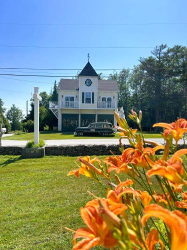a house with a clock tower on top of it at Hotel Pemaquid in Bristol