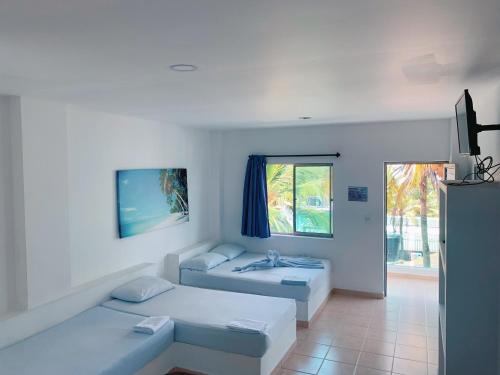 Postel nebo postele na pokoji v ubytování Blue Apartahotel