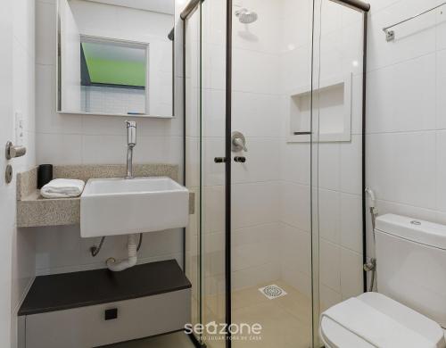 a bathroom with a sink and a toilet at Apto em cond Thai Beach Home Spa TBS1105 in Florianópolis