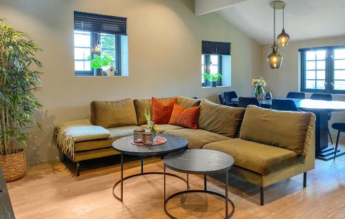 a living room with a couch and a table at Stunning Apartment In Oppdal in Oppdal