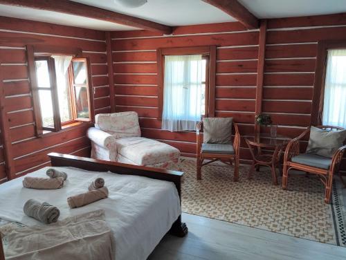 a bedroom with a bed and a table and chairs at Cottage Kolné in Stvolínky