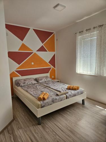 a bedroom with a bed with a geometric wall at Villa Stedar in Ohrid