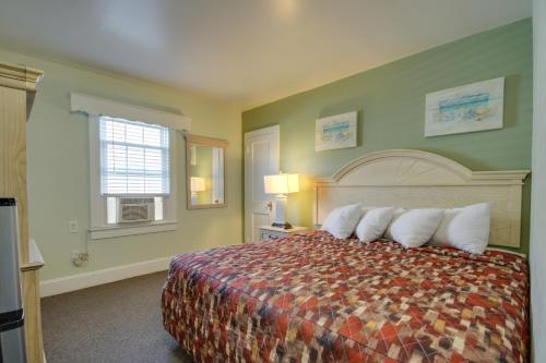 a hotel room with a bed with white pillows at Ocean Lodge Hotel South in Ocean City