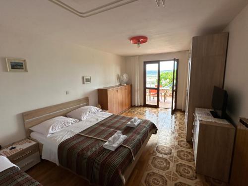 a bedroom with a bed and a television in it at Rooms and Apartments Roza in Portorož
