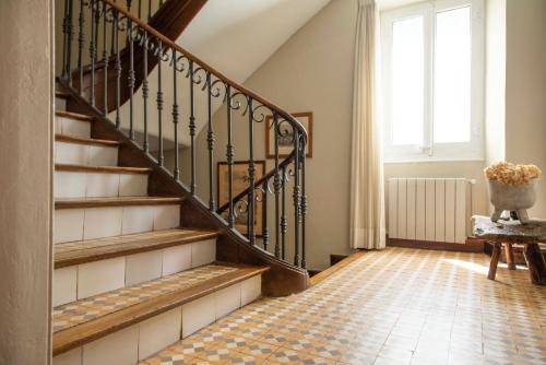 a staircase in a living room with a window at Mas Sant Marc in Puigcerdà