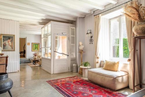 a living room with a couch and a door at Mas Sant Marc in Puigcerdà