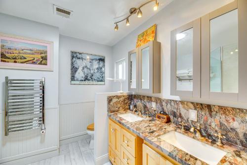 a bathroom with two sinks and a toilet at Vibrant Home with Patio - Near Santa Monica Pier! in Los Angeles