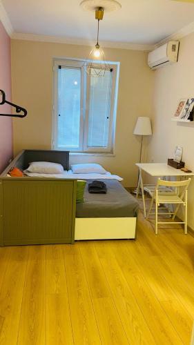 a bedroom with a bed and a table and a desk at Sapphire Suites Taksim in Istanbul