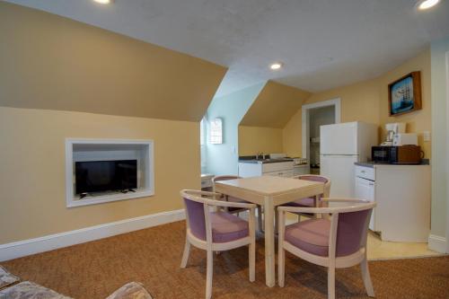 a kitchen with a table and chairs and a kitchen with a refrigerator at Ocean Lodge Hotel South in Ocean City