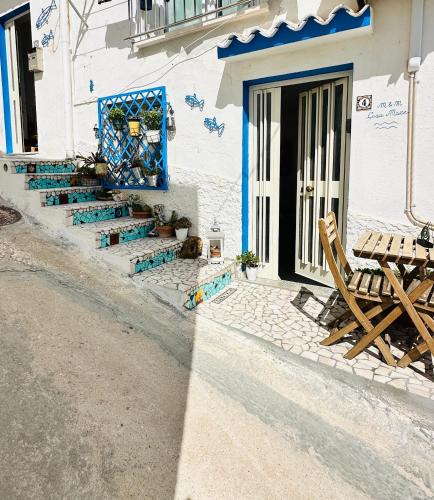a table and chairs sitting outside of a building at Casa M&M in Cala Gonone