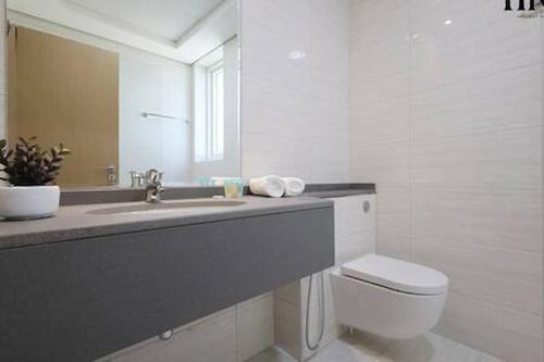 a bathroom with a sink and a toilet and a mirror at Gorgeous 2 Bed Apt in Al Warqa in Dubai