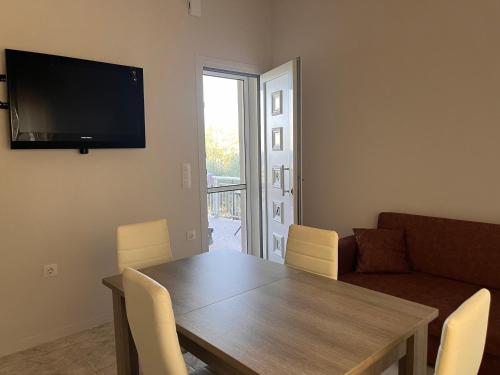 a living room with a table and a couch at Liostasi Hοuse in Mákri