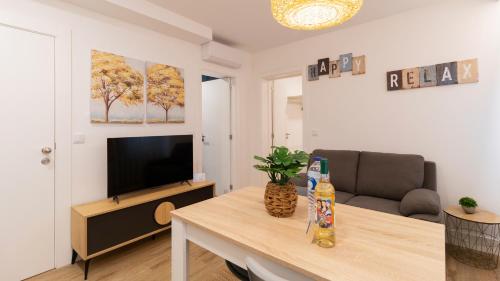 a living room with a table with a television and a couch at Stop & Relax - Parking in Porto