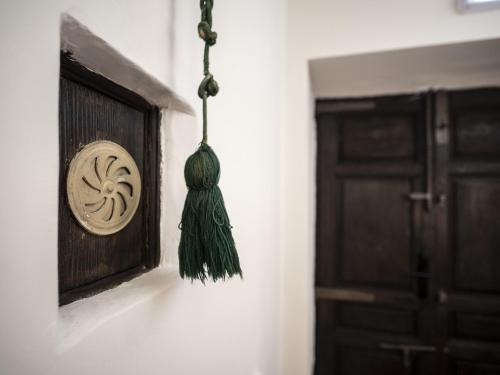 a tassel hanging from a wall next to a door at La Casa Amarilla apartamento Albarracin in Albarracín