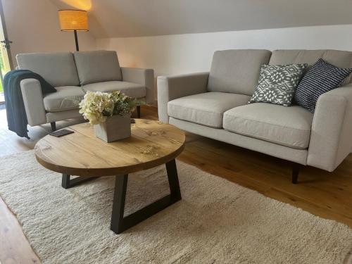 a living room with a couch and a coffee table at Studio-King Bed-Wye Valley Views in Trostrey