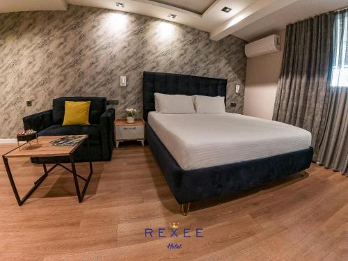 a bedroom with a bed and a couch and a chair at Taksim REXXEE Istanbul Istiklal Hotel in Istanbul