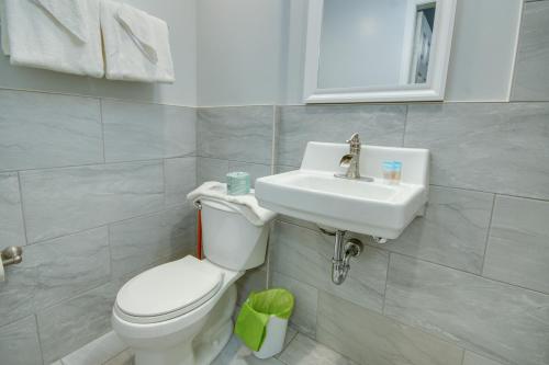 a bathroom with a white toilet and a sink at Ocean Lodge Hotel South in Ocean City