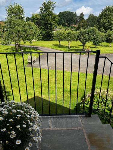 a black fence with a view of a park at Studio-King Bed-Wye Valley Views in Trostrey