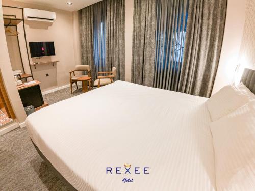 a hotel room with a white bed in a room at Taksim REXXEE Istanbul Istiklal Hotel in Istanbul
