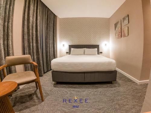 a hotel room with a bed and a chair at Taksim REXXEE Istanbul Istiklal Hotel in Istanbul