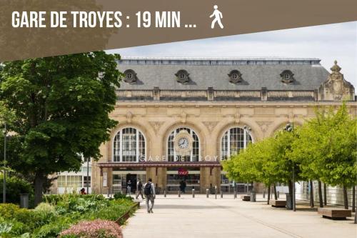 a large building with people walking in front of it at La maison du bonheur in Buchères