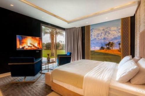 a bedroom with a large bed and a television at Villa des stars in Marrakesh