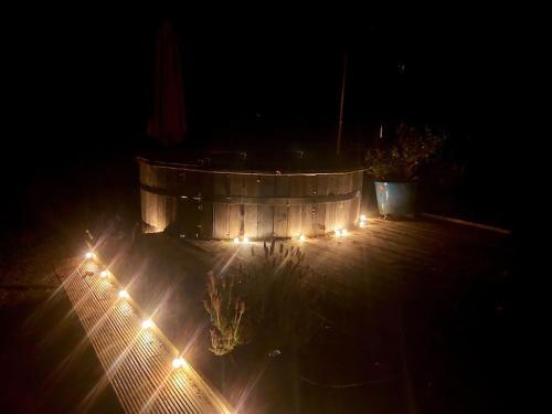 a bunch of lights on a patio at night at Caitríona's Cottages - Adult Only Pet Friendly - Hot Tub, Sauna, Pool - Sleeps 4 in Rossinver