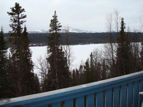 a view of a lake with trees and a fence at Fjällriket Baggården in Baggården