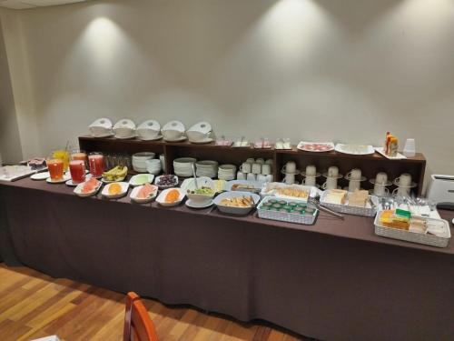a buffet with many different types of food on a table at Gran Hotel Ambassador in Cochabamba