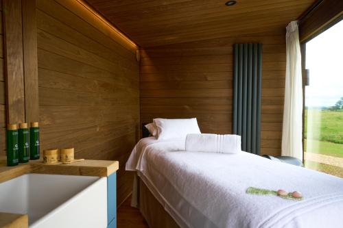 a bedroom with a white bed and a window at The Barnsdale, Rutland in Oakham