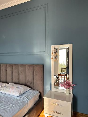a bedroom with a bed and a mirror at Horizon Hills - ჰორიზონ ჰილს in Kvariati