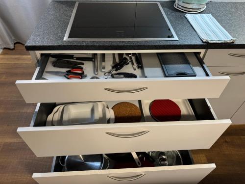 a kitchen island with an open drawer at La Lombardie - Charme et tranquillité in Sion
