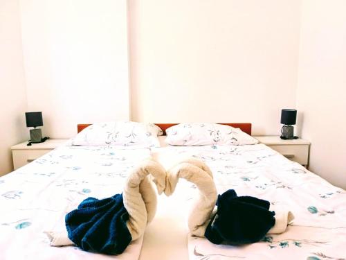 a bed with two towels in the shape of a heart at APARTMAN D&D , KRK-VRH in Vrh