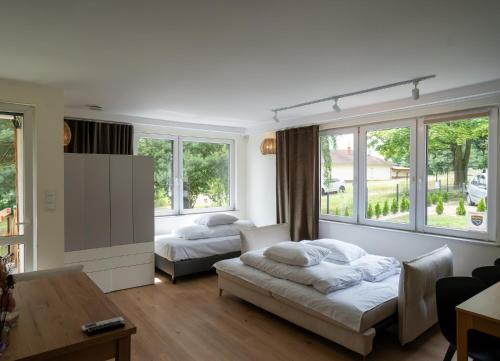 a living room with two beds and a couch at Domek Letniskowy 4E nad jeziorem nyskim in Skorochow