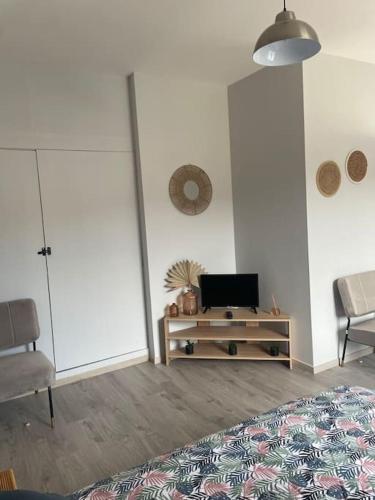 une chambre avec un lit et une table avec un ordinateur portable dans l'établissement Le Studio, à Vendeuvre-sur-Barse