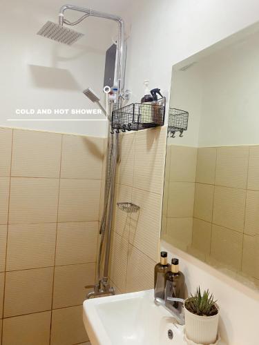 a bathroom with a sink and a mirror at Beans Crib Staycation at SMDC Green 2 Residences in Dasmariñas