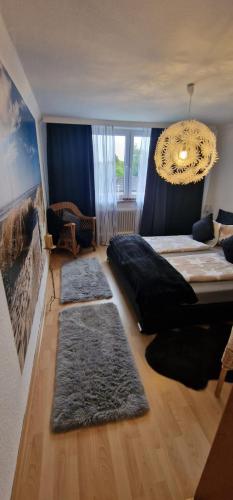 a bedroom with a large bed and two rugs at Stadtrand Haushälfte in Wilhelmshaven