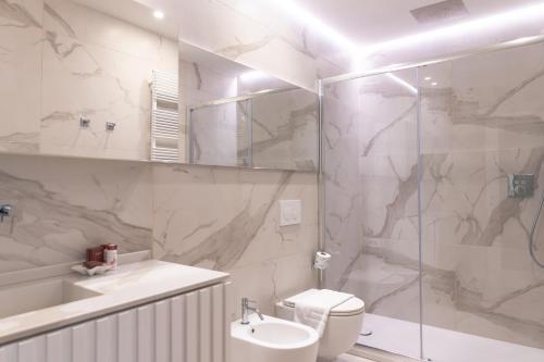 a bathroom with a shower and a toilet and a sink at About Italy Holiday Rooms and Apartments in Portovenere
