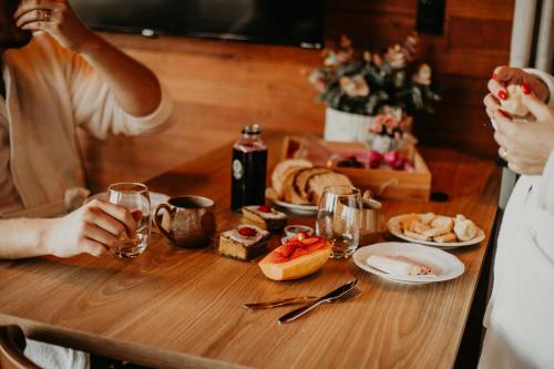 a group of people sitting at a table with food at Vale Tancon Eco Village Urubici in Urubici