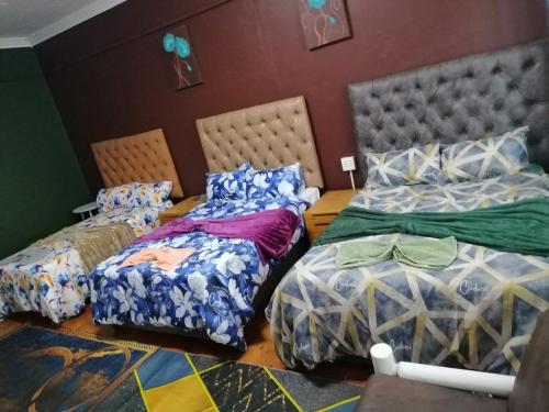 a room with two twin beds and a table at The trout Lodge in Cape Town