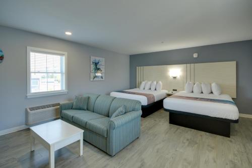 a hotel room with two beds and a couch at Ocean Lodge Hotel North in Ocean City