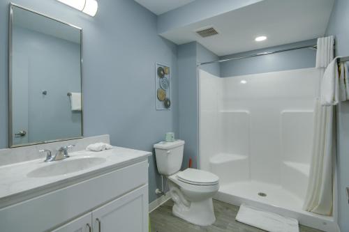 a white bathroom with a toilet and a sink at Ocean Lodge Hotel North in Ocean City