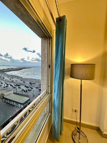 a room with a window with a view of the beach at Hyat Apartments in Alexandria