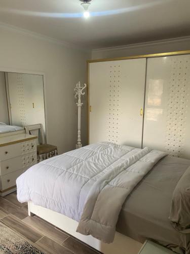 a bedroom with a large bed and a dresser at شقق فندقية راقي in Sheikh Zayed