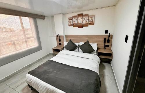 Postel nebo postele na pokoji v ubytování Hotel Fénix Real Bogotá