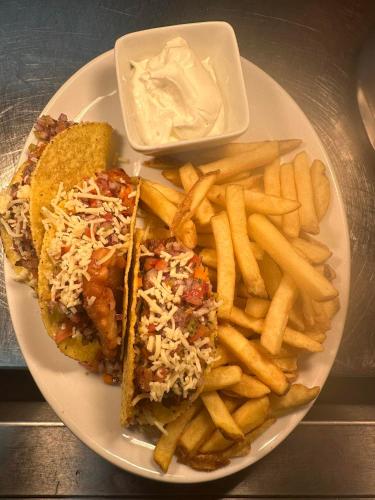a plate of food with a sandwich and french fries at The Lodges in Stanley