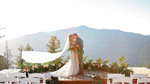 a bride and groom kissing at their wedding ceremony at Cozy Corner Tamarack Condo 19 in Tamarack